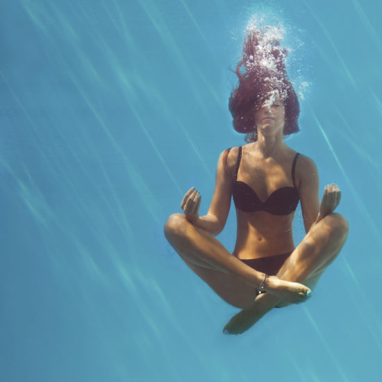 woman meditating under water