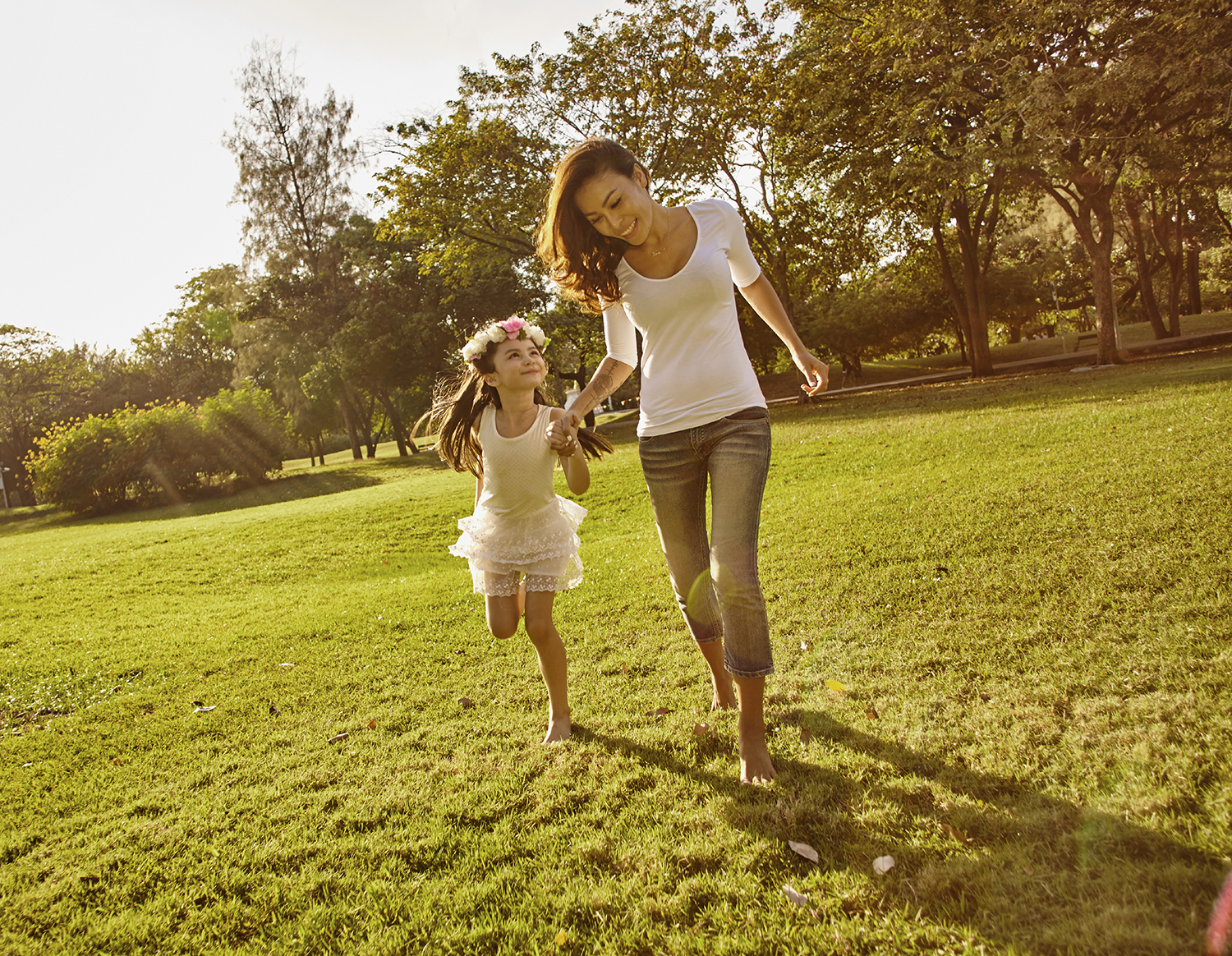 Lifestyle portrait mom and daughter in happiness at the outside in the meadow