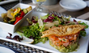 Salmon tartare with avocado, salad, crostini and roasted vegetables