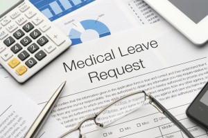 Medical leave request form on a desk.