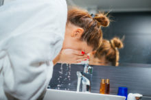 woman-rinsing-face