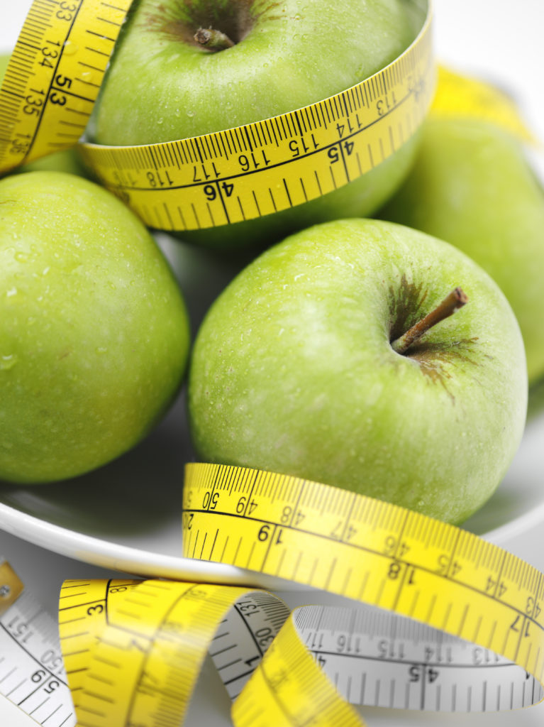 apples and tape measure to illustrate watching weight