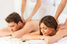 a couple receiving a massage from two masseuses