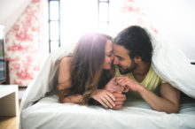 Couple-in-Bed-Enjoying-Time-Together