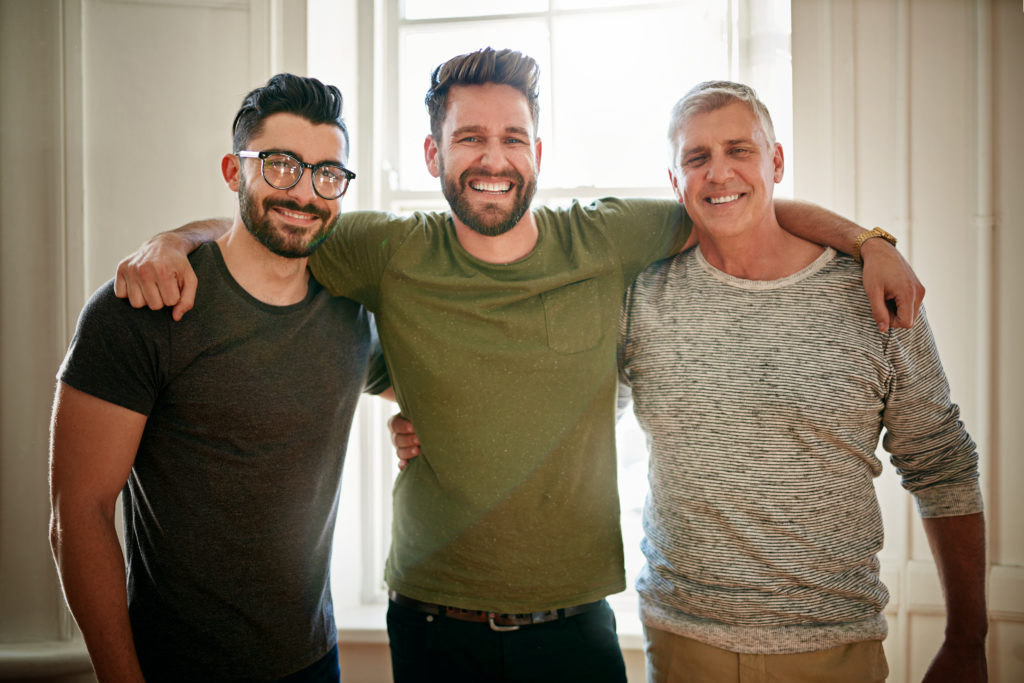 men-linking-arms-smiling