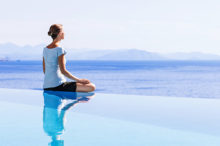 woman-meditating-poolside