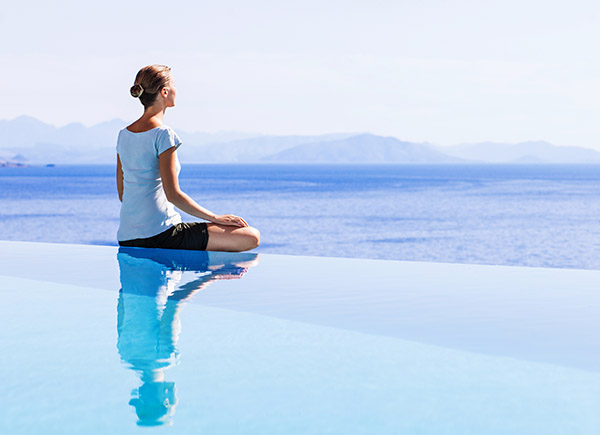 woman-meditating-poolside