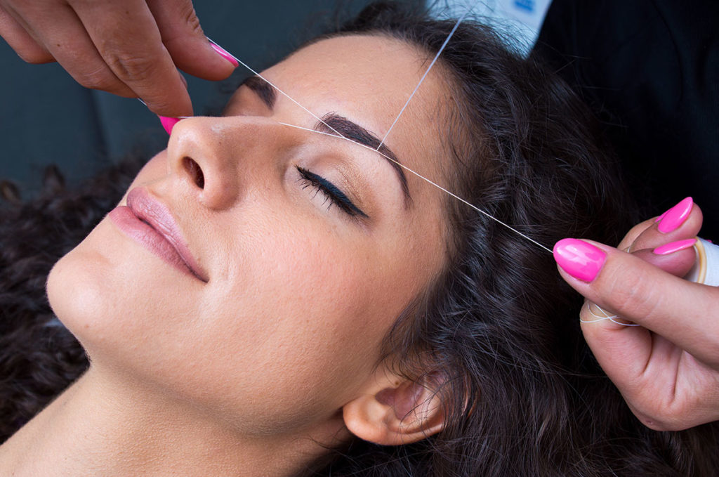 woman-threading-hair-removal