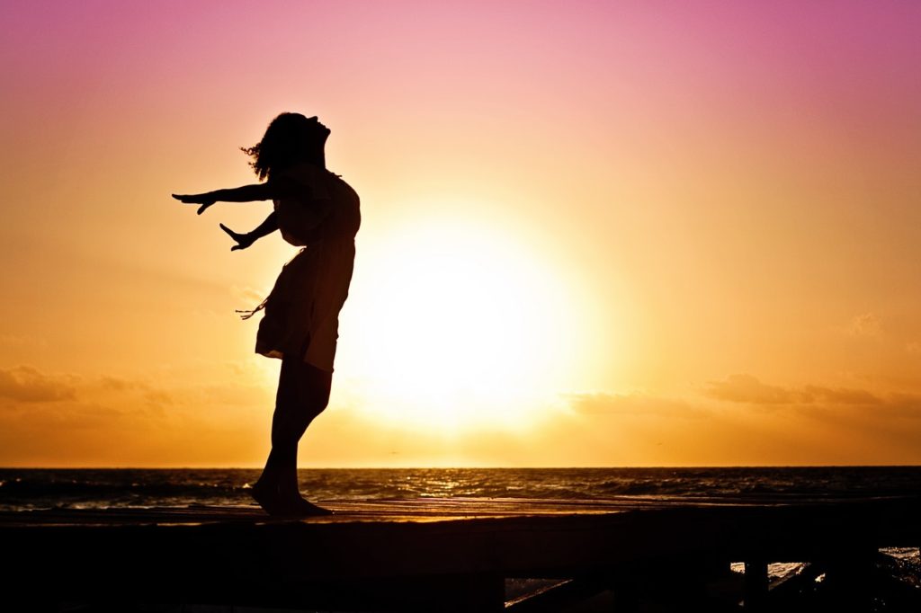 woman-windy-beach-sunset