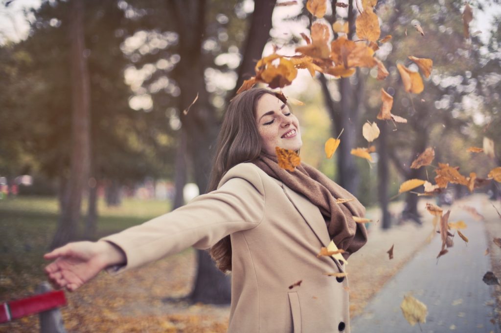 woman-throwing-leaves