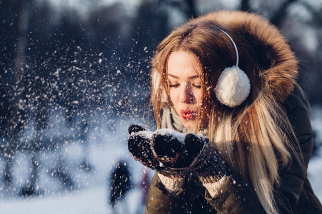 woman-blowing-snow