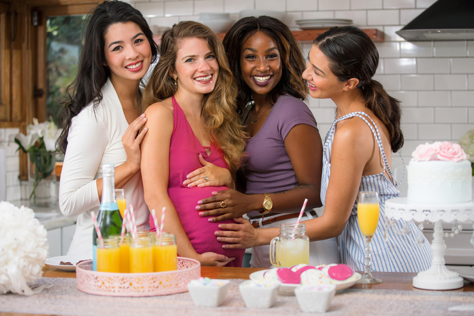 group of women hugging a pregnant woman
