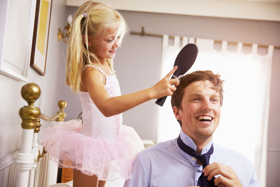 daughter brushing her father's hair before work